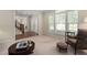Bright living room with large windows, neutral walls, and traditional furnishings at 1602 Eagle Lodge Ln, Durham, NC 27703