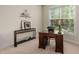 Functional office space with desk, shelving, and natural light from the window at 1602 Eagle Lodge Ln, Durham, NC 27703