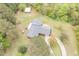 Overhead view of the home with mature trees, well-maintained lawn, and outbuilding at 1750 Spring Valley Lake Rd, Henderson, NC 27537