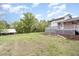 Spacious backyard with a deck and mature trees at 1750 Spring Valley Lake Rd, Henderson, NC 27537