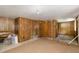Unfinished basement space with wood paneled walls and carpet at 1750 Spring Valley Lake Rd, Henderson, NC 27537