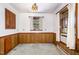 Cozy dining room with wood paneling and a window allowing natural light at 1750 Spring Valley Lake Rd, Henderson, NC 27537