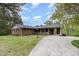 Lovely brick home featuring a covered front porch and a convenient covered parking area at 1750 Spring Valley Lake Rd, Henderson, NC 27537