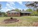 Charming brick home with well-manicured front yard and mature trees at 1750 Spring Valley Lake Rd, Henderson, NC 27537