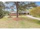 Charming brick home with a spacious front yard, mature trees, and a welcoming driveway at 1750 Spring Valley Lake Rd, Henderson, NC 27537