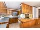 Well-lit kitchen with wood cabinets and a center island, providing ample space for cooking and storage at 1750 Spring Valley Lake Rd, Henderson, NC 27537