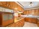 Functional kitchen with wood cabinetry, offering a classic design and efficient layout for meal preparation at 1750 Spring Valley Lake Rd, Henderson, NC 27537
