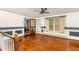 Bright room with hardwood floors, ceiling fan, large windows, and unique wall decor at 1750 Spring Valley Lake Rd, Henderson, NC 27537