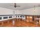 Bright living room with hardwood floors, ceiling fan, staircase, and duck-themed wallpaper at 1750 Spring Valley Lake Rd, Henderson, NC 27537