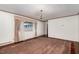 Spacious living room with carpet, large windows, classic trim, and a vintage chandelier at 1750 Spring Valley Lake Rd, Henderson, NC 27537