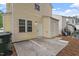Back of the home features yellow siding, a small patio and lots of space at 1808 Elkpark Dr, Raleigh, NC 27610