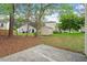 A spacious backyard with mature trees, lush grass, and a small storage shed at 1808 Elkpark Dr, Raleigh, NC 27610