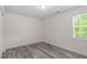Bedroom with modern gray floors and a bright window at 1808 Elkpark Dr, Raleigh, NC 27610