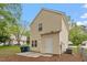 The rear of the home shows yellow siding, a small patio, and fenced yard at 1808 Elkpark Dr, Raleigh, NC 27610