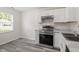 Modern kitchen features stainless steel appliances, light countertops, and neutral decor, creating a stylish and functional space at 1808 Elkpark Dr, Raleigh, NC 27610