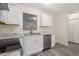 Well-lit kitchen with white cabinets, stainless steel appliances, and sleek countertops provides a contemporary and functional cooking space at 1808 Elkpark Dr, Raleigh, NC 27610