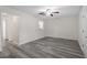 Open living room with stylish gray floors and view of the kitchen and hallway at 1808 Elkpark Dr, Raleigh, NC 27610