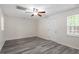 Spacious living room with ceiling fan, natural light, and neutral colors provides a versatile and comfortable living area at 1808 Elkpark Dr, Raleigh, NC 27610
