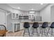 Basement bar with seating, stainless steel appliances, and custom shelving at 1911 Firenza Dr, Apex, NC 27502