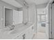 Bright bathroom featuring double sinks with white cabinets and a large mirror at 1911 Firenza Dr, Apex, NC 27502