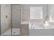 Bathroom featuring a soaking tub and glass enclosed shower at 1911 Firenza Dr, Apex, NC 27502