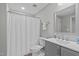 Bathroom with shower/tub, grey vanity, and a framed mirror at 1911 Firenza Dr, Apex, NC 27502