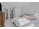 Bedroom with ensuite bathroom access; carpet, neutral walls, and two windows at 1911 Firenza Dr, Apex, NC 27502