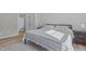 Bright bedroom featuring a striped bedspread, ensuite bathroom and LVP floors at 1911 Firenza Dr, Apex, NC 27502