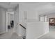 Hallway with stairs to downstairs and a game room behind an open door at 1911 Firenza Dr, Apex, NC 27502