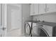 Convenient laundry room with modern, stainless steel washer and dryer units at 1911 Firenza Dr, Apex, NC 27502