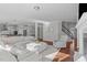 Spacious living room with hardwood floors, neutral paint, and a cozy seating arrangement at 1911 Firenza Dr, Apex, NC 27502