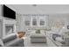 Bright and airy living room with fireplace, built-in shelving, and seamless flow to adjacent areas at 1911 Firenza Dr, Apex, NC 27502