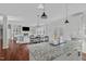 Open-concept kitchen with granite counters connects to a sunlit living room with built-ins and a fireplace at 1911 Firenza Dr, Apex, NC 27502