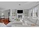 Bright living room features built-in shelving around a fireplace and large windows for natural light at 1911 Firenza Dr, Apex, NC 27502