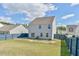 Spacious backyard with a well-maintained lawn and blue fence is ideal for relaxing and outdoor activities at 2065 Alderman Way, Creedmoor, NC 27522