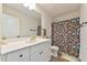 Well-lit bathroom features a modern vanity, a shower with a fun shower curtain, and wood-look floors at 2065 Alderman Way, Creedmoor, NC 27522