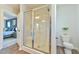 Bathroom with a glass-door shower, toilet, and a view leading to the bedroom at 2065 Alderman Way, Creedmoor, NC 27522