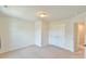 Neutral bedroom featuring carpet floors, a double door closet, and easy access to the ensuite bathroom at 2065 Alderman Way, Creedmoor, NC 27522