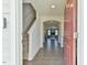 Inviting entryway with wood flooring, staircase, and view into the living room at 2065 Alderman Way, Creedmoor, NC 27522