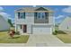 Charming two-story home with a two-car garage and well-maintained landscaping at 2065 Alderman Way, Creedmoor, NC 27522