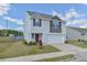 Well-kept two story home featuring a two-car garage, lawn and manicured landscape at 2065 Alderman Way, Creedmoor, NC 27522