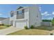 Corner view of a two-story home showing the two-car garage, yard and siding at 2065 Alderman Way, Creedmoor, NC 27522