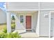 Close up of front door showing the door number, small window, and surrounding landscape at 2065 Alderman Way, Creedmoor, NC 27522