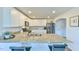 Spacious kitchen featuring granite countertops, stainless steel appliances, and bar seating at 2065 Alderman Way, Creedmoor, NC 27522