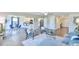 Open-concept living space with hardwood floors, ample lighting, and a view into the kitchen at 2065 Alderman Way, Creedmoor, NC 27522