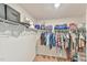 Walk-in closet featuring ample storage space with metal racks and neutral carpet at 2065 Alderman Way, Creedmoor, NC 27522