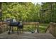 Back deck with grill, potted plants, and wooded views at 2108 Canterbury Rd, Clayton, NC 27520