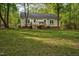 Spacious backyard featuring a wooden deck with a picnic table, perfect for outdoor entertaining at 2108 Canterbury Rd, Clayton, NC 27520