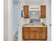 Well-lit bathroom featuring a vanity with wooden cabinets and a granite countertop at 2108 Canterbury Rd, Clayton, NC 27520