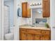 Inviting bathroom with wooden cabinetry, granite countertop, and soft lighting at 2108 Canterbury Rd, Clayton, NC 27520
